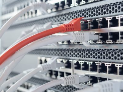 Working switches in data center with white and red cables